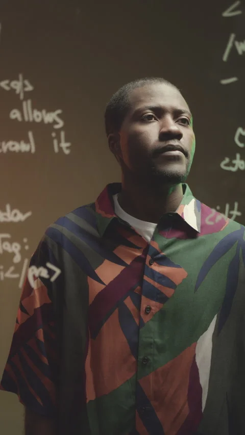 Black Man Looking at Computer Command on Glass Board Stock Footage 259936949