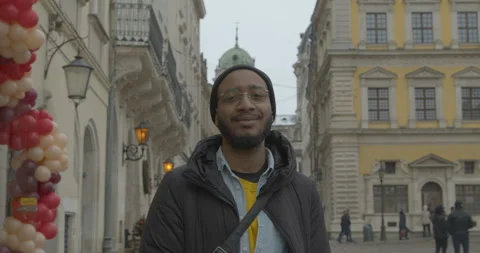 Black man looks in camera standing in old city downtown 스톡 동영상 170151421