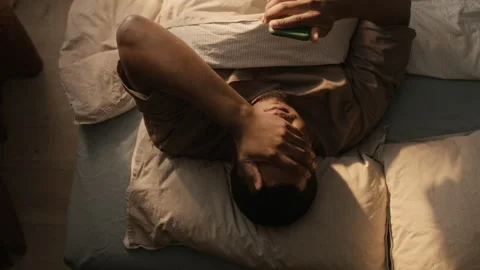 Black Man Lying in Bed Rubbing Face Feeling Tired from Insomnia Vídeo Stock 337715356