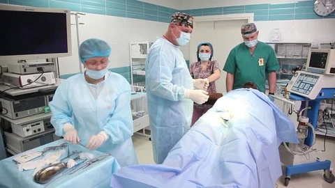 Black man lying on the operating table under anesthesia. in the operating room Stock Footage 75060267