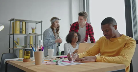 Black man making notes near diverse colleagues Stock Footage 154698903
