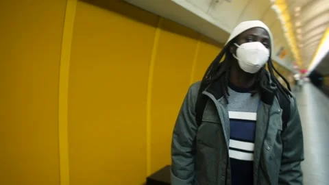 Black man in mask waiting train station He comes station train arrives Stock Footage 149369082