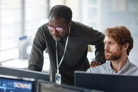 Black Man Mentoring IT Developer and Reviewing Code Stock Photos
