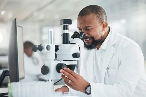 Black man, microscope and smile for scientist in lab with sample or medical.. Stock Photos
