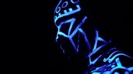 A Black Man In Neon Patterns On A Body With A Wooden Necklace On His Neck Stands Stock Footage
