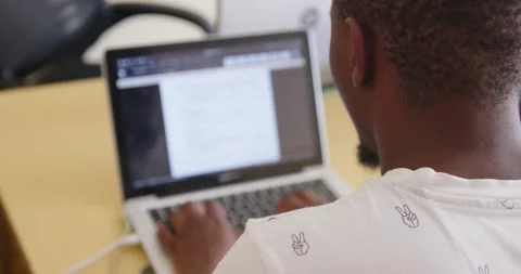 Black Man in an office typing on a computer Stock Footage 184960841