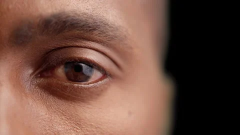 Black man opening eye on dark background, eyesight examination, optometry Stock Footage 160034907
