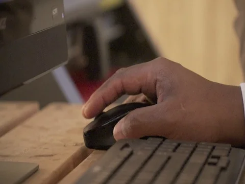 Black man operating keyboard and mouse in office 動画素材 78609842