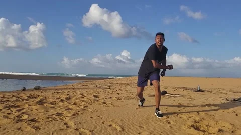Black Man Performs Martial Arts Tricking, Jump 360 Spinning Hook Kick on Beach Stock Footage 146564934