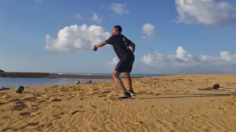 Black Man Performs Spinning Hook Kick on Beach, Martial Arts Stock Footage 146564908