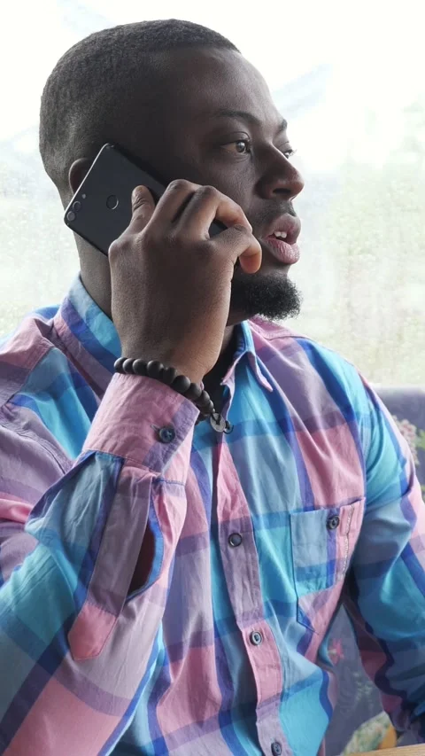 Black Man On Phone Inside Bus, Wearing Pink Blue Plaid Shirt And Bracelet 스톡 동영상 333903569