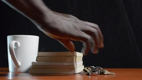 Black man picking up keys from the table Stock Footage 276594450