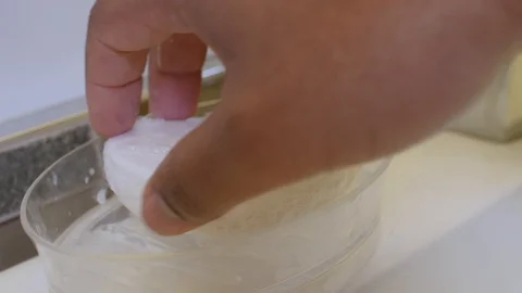 Black man picking up soap Stock Footage 126745417