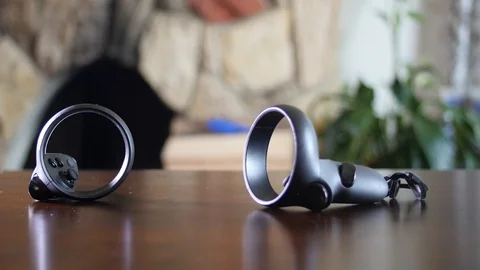 Black man picking up VR controllers Stock Footage 126871118