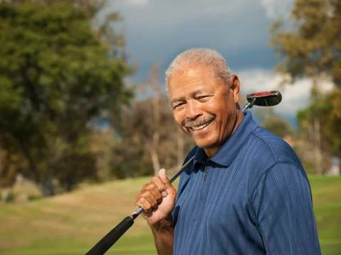 Black man playing golf Photos