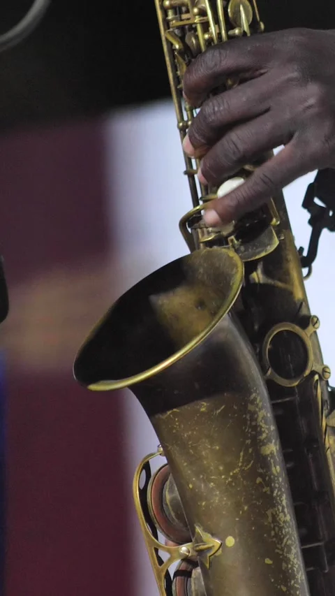 Black man playing the keys of a saxophone Video stock 228828151