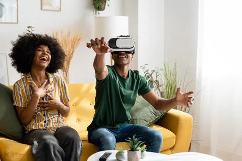 Black man playing VR game at home Stock Photos