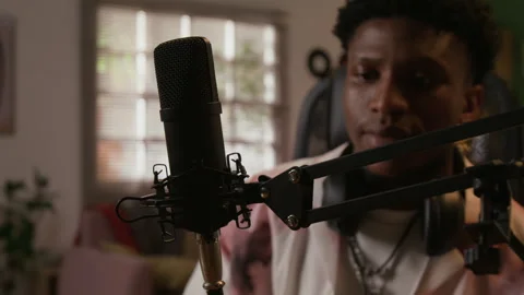 Black Man Plugging Wire into Microphone Preparing Audio Equipment in Home Studio Stock Footage 335398597