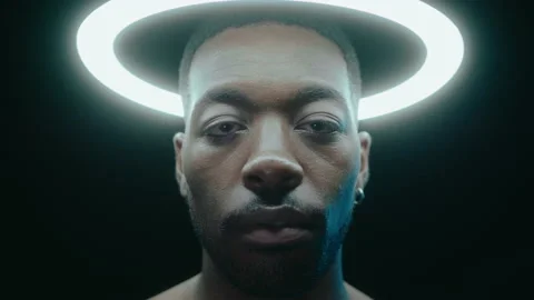 Black Man Posing Under Ring Light in Dark Studio Stock Footage 236688417