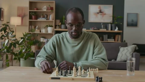 Black Man Practicing Chess Moves during Self-Preparation at Home Stock Footage 290464334