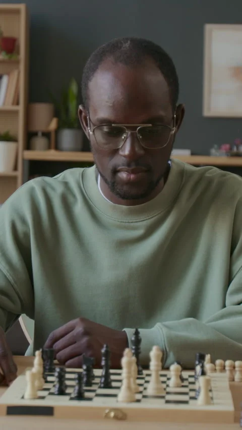 Black Man Practicing Chess Moves and Planning Game Strategy at Home Stock Footage 291828591