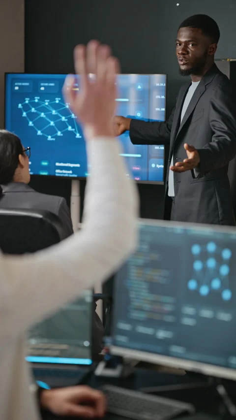 Black Man Presenting Cybersecurity Data to Colleagues in Office Stock Footage 346817608