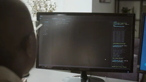 Black Man Programming Software on Desktop Computer Screen Stock Footage 348143401