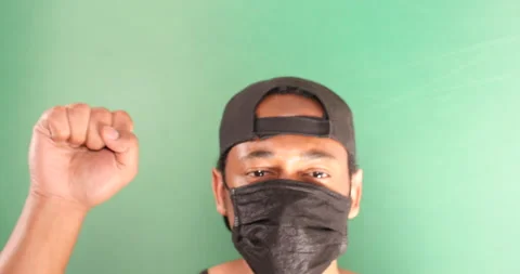 Black man protesting in face mask on green screen Stock Footage 133473824