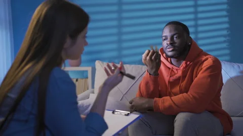 Black man with psychological problems seeks help from psychiatrist. Stock Footage 228806800