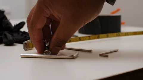 Black man puts down small screws Stock Footage 129201364