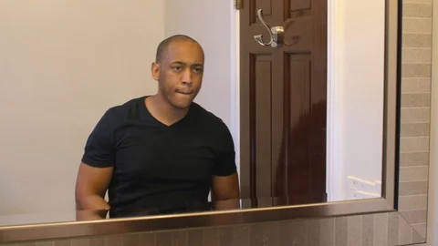 Black man putting on face mask Stock Footage 126747196