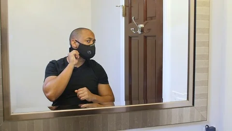 Black man putting on face mask in slow motion Stock Footage 126798640