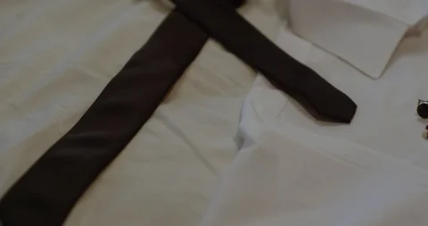 Black man putting out cuff links on shirt Video stock 127211740