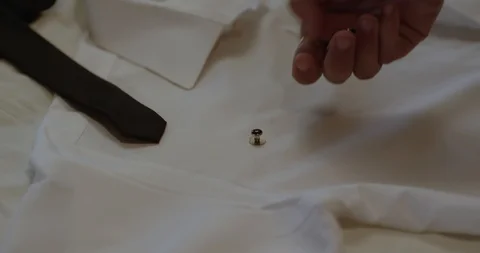 Black man putting out cuff links on shirt 스톡 동영상 127212158