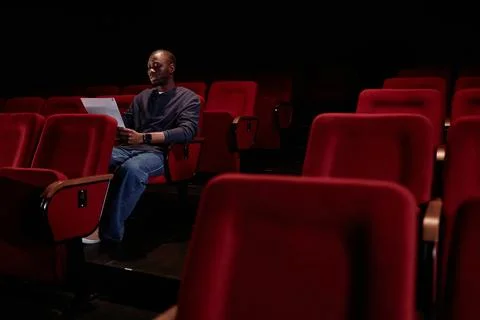 Black Man Reading Lines in Empty Theater Stock Photos