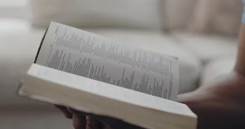 Black man reading from open Bible in hands, Closeup Detail of book Stock Footage 151839696