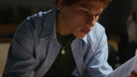 Black Man Reading Script during Student Theater Rehearsal Stock Footage 344519532