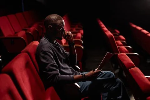Black Man Reading Script in Empty Theater Stock Photos