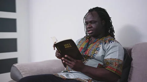 Black Man Reading Scriptures On The Holy Bible With Rosary. - medium shot 스톡 동영상 141937528