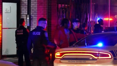 Black man with red coat being detained by officers Stock Footage 138620188