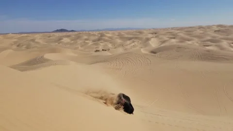 Black Man Rolls Down Large Sand Dune in Sonoran, Yuma, Arizona Stock Footage 146552493
