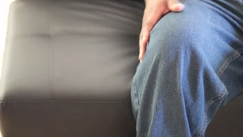 Black man rubbing knee Stock Footage 83179909