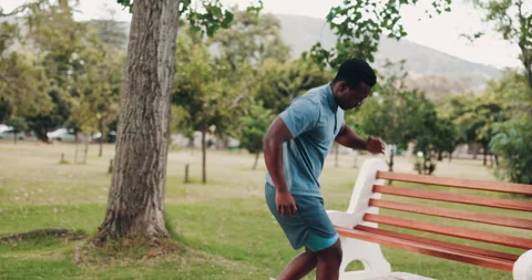 Black man, running and break with park bench for ankle sprain, accident or Stock Footage 301023145