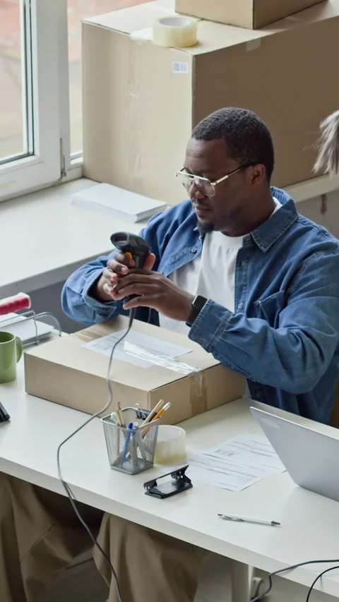 Black Man Scanning Barcode on Package for E-commerce Delivery 動画素材 337305468