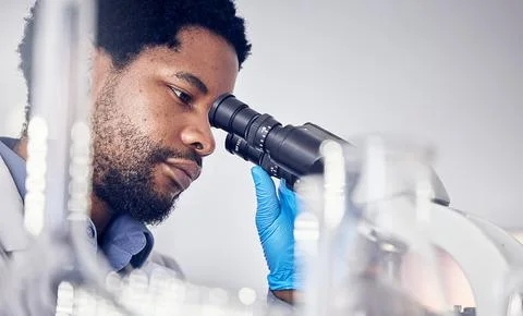 Black man, scientist and microscope with science research in laboratory, data Foto stock