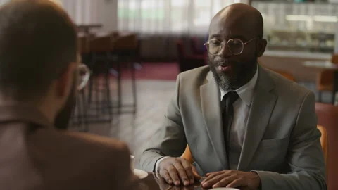Black Man Shaking Hands and Talking with Business Partner in Hotel Lounge 스톡 동영상 333631619