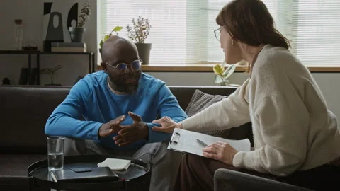 Black Man Sharing Problems with Female Therapist in Counseling Session Stock Footage 337643652