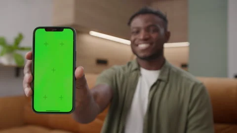 Black Man Showing Green Screen Cell Phone. African American man holds smartphone Stock Footage 252114498