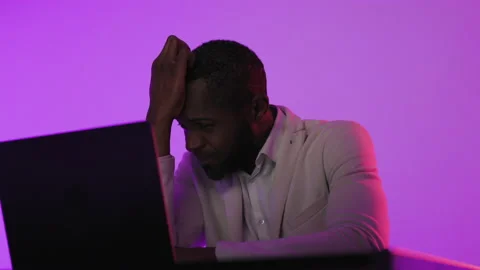 Black Man Sitting at Desk Working on Laptop Computer. African American Man Stock Footage 231435163