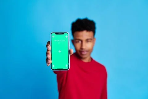 Black man with smartphone in studio Stock Photos